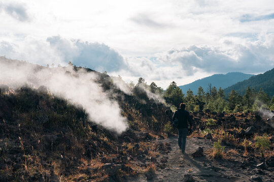 One man walking on a trail next to fumaroles of Paricutin volcano