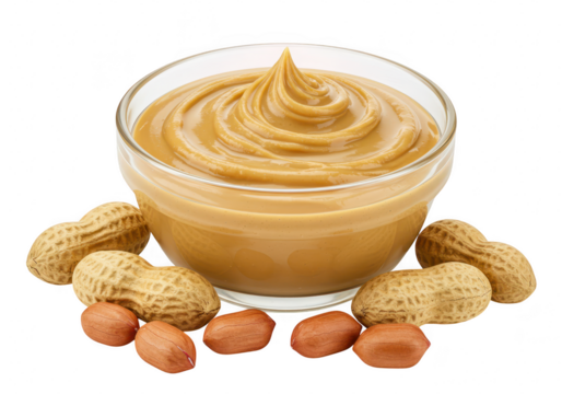 A glass bowl filled with creamy peanut butter surrounded by peanuts and shells, isolated on a transparent background