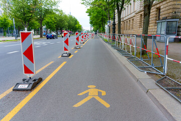 Urban Sidewalk Construction in Berlin with Pedestrian Signage and Barriers