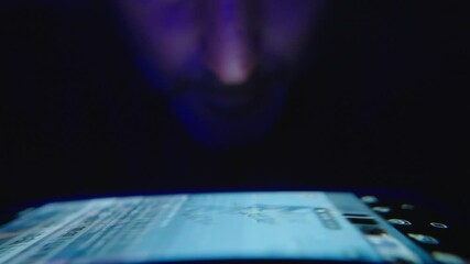 Middle aged man dark room colorful lighting tech-driven social media addiction scrolling feeds automatically digital distraction modern routine