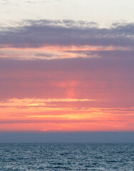 The sky is a beautiful pink color with a few clouds