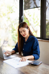 Computer and papers. Focused asian woman office worker Entrepreneur freelancer do paperwork manage...
