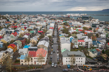 High angle view of downtown Reykjav&iacute;k in Iceland, featuring colourful ironclad houses and Faxafl&oacute;i Bay in the background