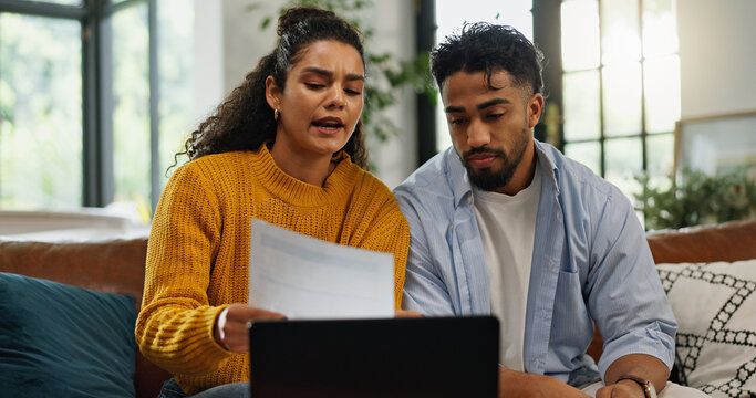 Home, talking and couple with bills in lounge, financial plan and asset management with information. Serious, man or woman with paperwork for analysis, laptop or discussion with report in living room