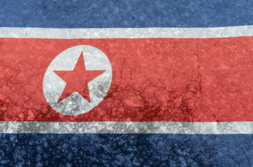 The national flag of North Korea on a background of snow with large snow crystals in close-up