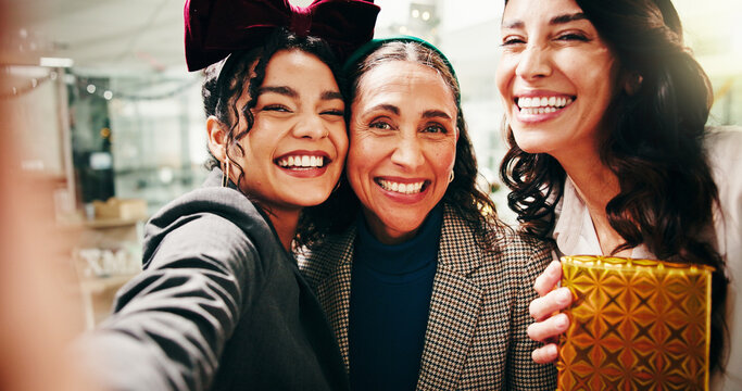 Christmas, business women and team selfie with gift, festive celebration and POV. Picture, portrait and photo of friends with xmas present for holiday, party or laugh for social media post in office