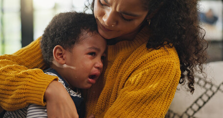 Crying, comfort and mom with child on sofa with pain for teething, growing and development in home....