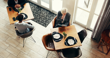Mature business woman, tablet and coffee shop for remote work, reading and above for review at...