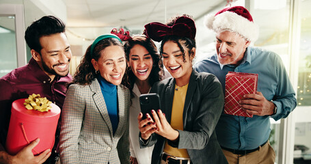 Christmas, notification and phone with excited business people in office together for sharing news. Announcement, app and collaboration with happy employee team in workplace for festive alert
