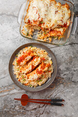 Hong Kong food baked pork chop with fried rice, tomato sauce and melted cheese on top close-up. vertical top view from above