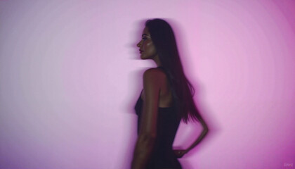 Silhouette of a young woman in profile against a purple gradient background, artistic motion