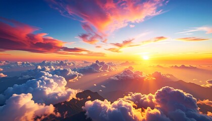 Aerial view of a vibrant sunset over mountainous terrain, with dramatic clouds