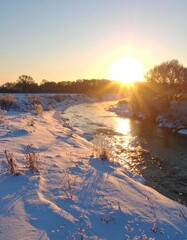 Winter sunrise over a snow-covered river