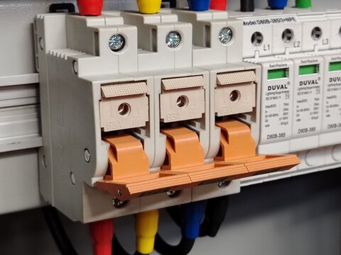 Image of fuse switches and surge protective devices in a panel.