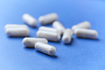 Arginine capsules on bright background. Soft focus. Close up. Copy space.	