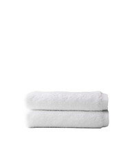 Soft white towels neatly stacked on a clean surface (1)