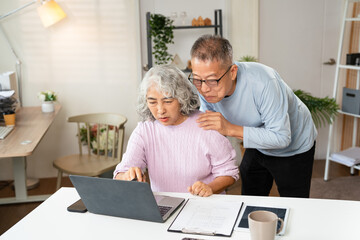 Retirement, senior couple and ecommerce on laptop for home purchase finance decision together....