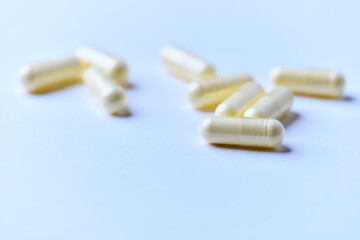 Alpha-lipoic acid capsules. Paper background. Soft focus. Close up. Copy space.	