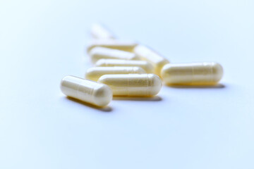 Alpha-lipoic acid capsules. Paper background. Soft focus. Close up. Copy space.	