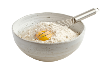 Egg yolk in flour bowl with whisk baking ingredients