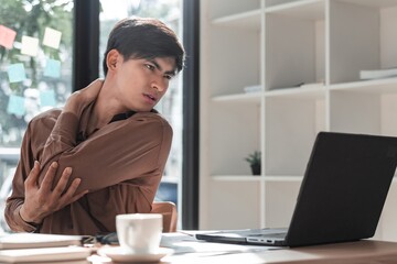 Young Man Experiencing Discomfort While Working from Home Office