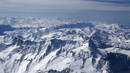 Aerial view of snow-covered Alps mountain range 