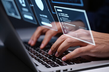 Close up of hands typing on laptop with futuristic holographic interface overlaying the keyboard