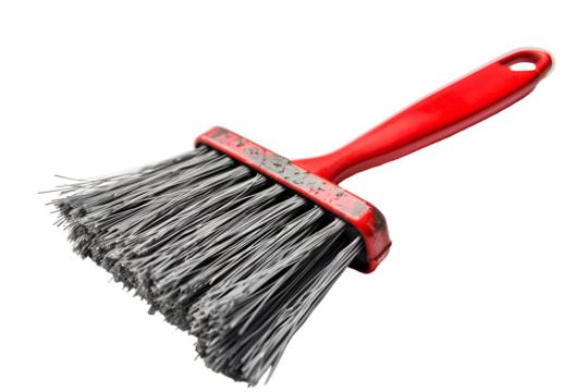 Red handled brush with gray bristles isolated on black background