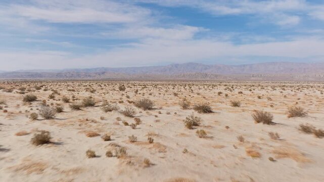 Explore the expansive Barstow desert in California with breathtaking aerial shots. The video captures the serene landscape, highlighting the calming mood of this arid environment under a clear sky.