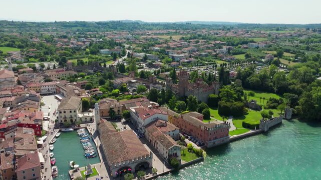 A breathtaking aerial shot of Lazise&rsquo;s vibrant harbor and the imposing medieval castle on the eastern shore of Lake Garda, Italy.