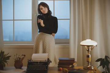 Stylish Woman Standing Thoughtfully In Creative Workspace With Vintage