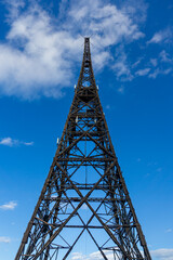Vertical composition showing the wooden radio tower of Gliwice against a clear sky