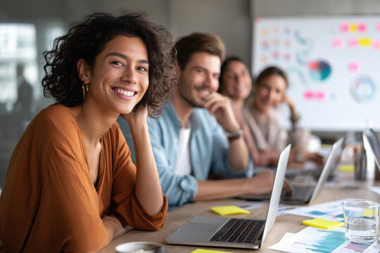 happy business people working together on laptop at office