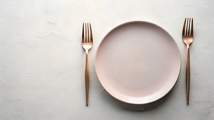 An empty plate with two forks is set on a clean surface, ready for a formal dinner or special occasion