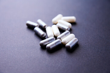 Creatine and BCAA amino acids capsules. Nutrition for bodybuilding. Fitness supplements on paper background. Soft focus. Copy space.	