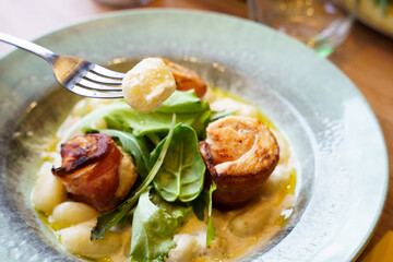 Gnocchi with creamy sauce and bacon-wrapped chicken