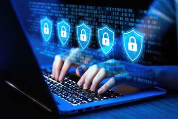 Person typing on laptop with digital security shields and binary code overlay in blue hue