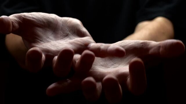 A surge of adrenaline and severe stress in a man on a black background.
Trembling in the limbs and tremors of the hands caused by problems with the nervous system.
Parkinson's disease in a man 