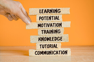 Businessman Building LEARNING concept with Brick Blocks. Beautiful wooden table orange background....