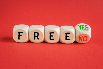 Free symbol. Turned a wooden cube and change words Free YES to Free No. Beautiful red background....