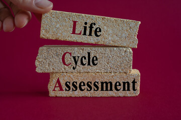 Life Cycle Assessment symbol. Concept words LCA Life Cycle Assessment on brick blocks. Beautiful...