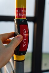 Hand Pressing Stop Button in Bus