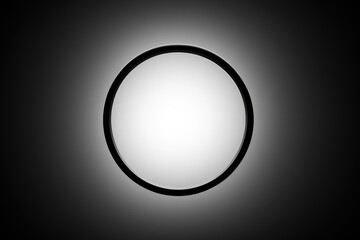 Minimalist monochrome presentation of a circular shape on a gradient, showcasing light and shadow in simple design.