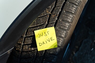 Just Drive – Handwritten Note on Car Tire