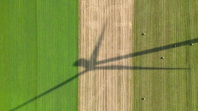 Shadow of a wind turbine on a field near Czaple village, Mazowsze, Poland, 4k video
