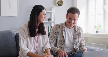 Family couple spends leisure time together, using a laptop at home. Online entertainment, happy conversation, and bond through internet connectivity, emphasizing quality time and relaxation. - Powered by Adobe