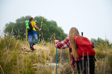 Two Hikers Climbing a Mountain Trail Surrounded by Nature