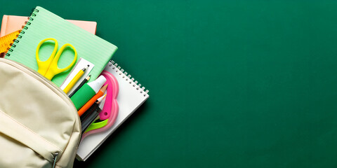 Backpack with colorful school supplies on green background. Back to school sale banner design.