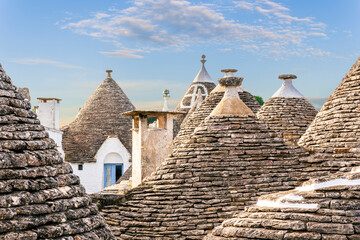 mediterranean vintage architecture with old tile roofs with white walls and beautiful high peaks on blue cloudy sky background
