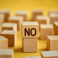 Wooden Building Blocks Spelling No on a Yellow Background, Negation Concept